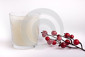 Candle in glass on white background with red berries, product mock-up