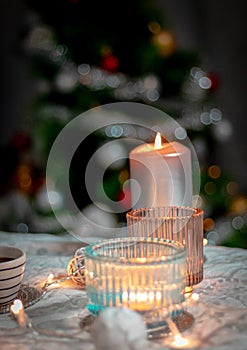 candle in the hands of a woman in a hand on a background of a burning candles