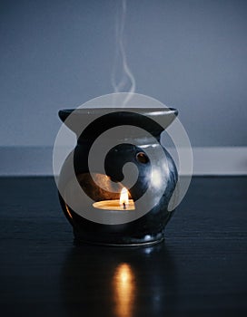 A candle that heats a fragrant oil,  with steam