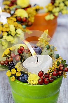 Candle holder decorated with autumn flowers