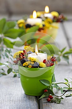 Candle holder decorated with autumn flowers