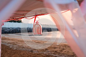 Candle holder hanging from beach cabana