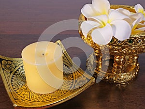 Candle, lacquer wares, and tropical flowers