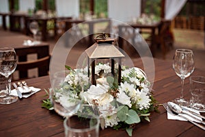 Candle in the lantern. Beautiful flower decorations with candles for the wedding ceremony.