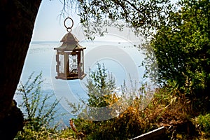 Candle lantern hanging on a tree branch