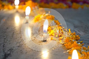 CANDLE LIGHT BACKGROUND WITH MERIGOLD FLOWER