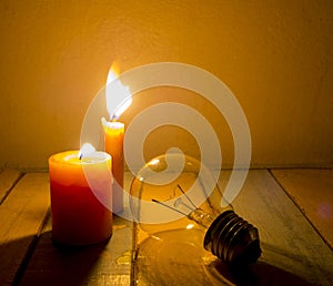 Candle light shine on incandescent bulb photo