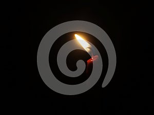 candle light shining in the darkness