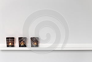 Candle lights on white shelf