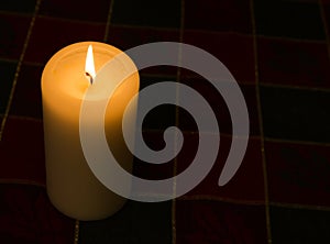 Candle lir against dark background with copy space