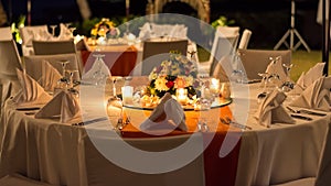 Candle lit outdoor table setting at function