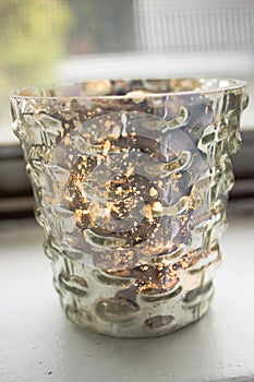 Candle in a mercury glass votive