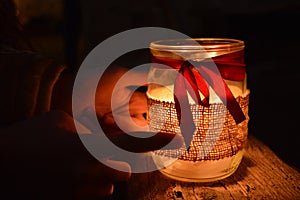 Candle in the night with red ribbon 