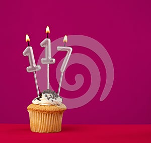 Candle number 117 - Cake birthday in rhodamine red background