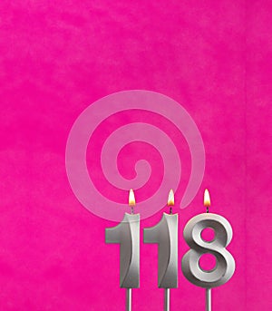 Candle number 118 - Birthday celebration on fuchsia background