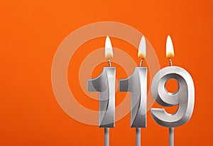 Candle number 119 - Birthday in orange background