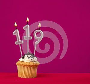 Candle number 119 - Cake birthday in rhodamine red background