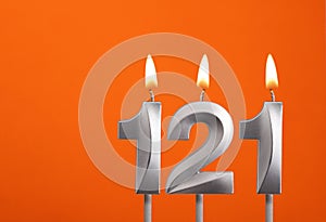 Candle number 121 - Birthday in orange background