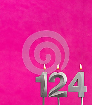 Candle number 124 - Birthday celebration on fuchsia background