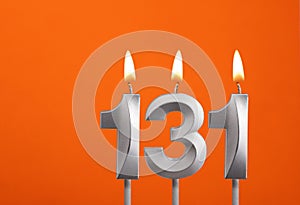 Candle number 131 - Birthday in orange background