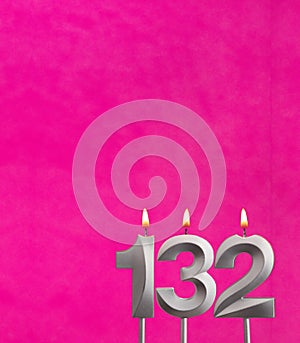 Candle number 132 - Birthday celebration on fuchsia background