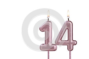 Candle number 14 - Lit birthday candle on white background