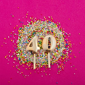 Candle number 40 - Birthday or anniversary on rhodamine red background