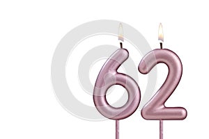 Candle number 62 - Lit birthday candle on white background