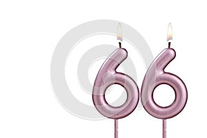 Candle number 66 - Lit birthday candle on white background
