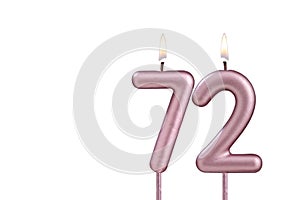 Candle number 72 - Lit birthday candle on white background