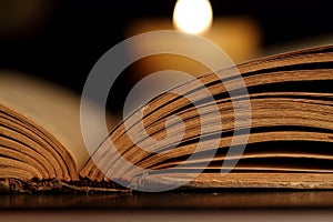 Candle and Opened Old Bible