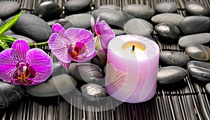 candle with orchids and lava stones