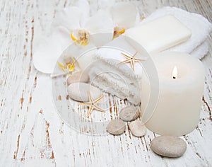 Candle, orchids and towels