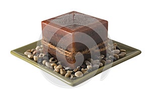 Candle on plate with stones - unlit