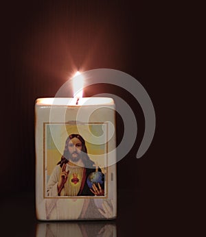 Candle with religion motiff