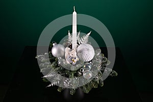 Candle Resting on Christmas Arrangement