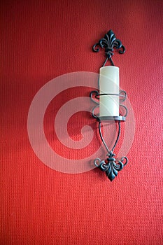 Candle sconce on red wall