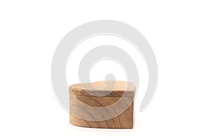 A candle in the shape of a heart. On a white background. A wooden candle