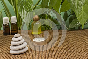 Candle and spa stones, green leaves. SPA relaxation concept