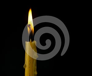 Candle with wax dripping and smoke patterns curling from wick highlighted photo