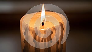 Candle is white with melted wax drippings creating a textured