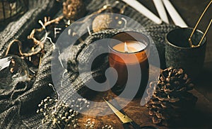Candle on wooden board, sweater and decoration toys, horizontal composition