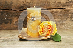 Candle and yellow rose