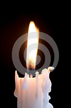 Candleflame on a lit white candle
