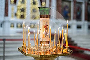 Candleholder and image of Jesus in church close