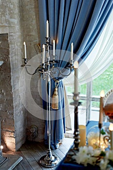 Candleholder on a long leg of the led candles.Wedding decoration of the hall. photo