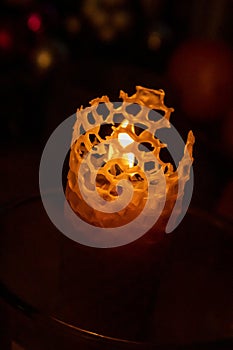 Candlelight on a dark winter evening shining through the lattices photo