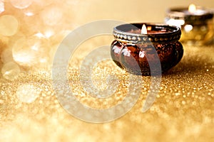 Candlelights on golden glittering background