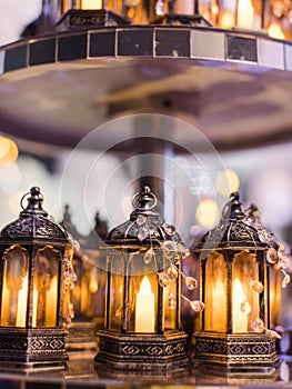 Candlelit dinner setting with an array of candles on a plate, illuminated by ambient lighting