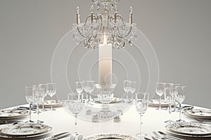 A candlelit dinner setting with an elegant crystal chandelier hanging above a round table.